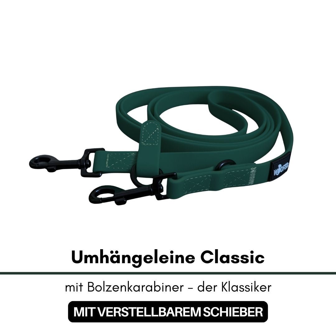 Dunkelgrüne Umhängeleine, zusammengerollt, mit zwei schwarzen Bolzenkarabinern und verstellbarem Schieber