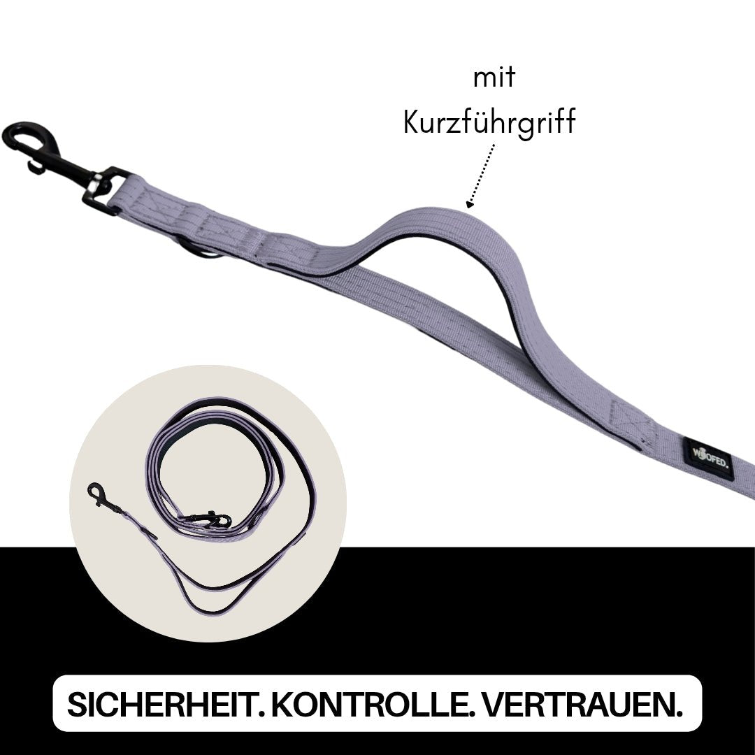 Helllila Nylon‑Führleine schräg liegend mit gepolstertem Kurzführgriff, schwarzem Karabiner und aufgerollter Detailansicht