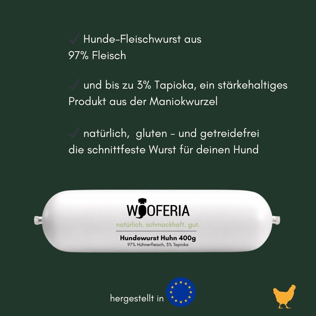 weiße zylindrische Hundewurst (horizontal), Vorderseite mit WOOFERIA‑Label und Aufdruck 'Hundewurst Huhn 400g' auf dunkelgrün