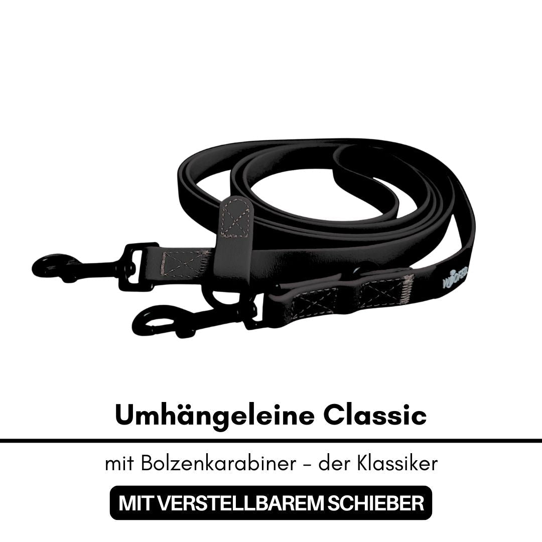 Schwarze, aufgewickelte WOOFLEX Umhängeleine mit zwei Bolzenkarabinern und verstellbarem Schieber, Draufsicht