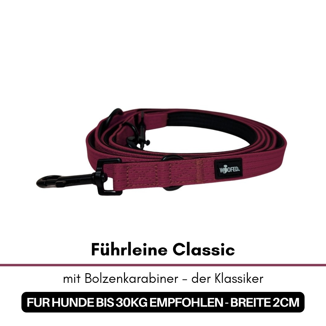 Bordeauxfarbene, flach aufgewickelte Führleine Classic mit schwarzem Bolzenkarabiner und WOOFED-Logo